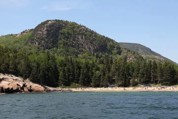 a body of water with a mountain in the background
