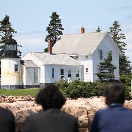 a group of people in front of a house