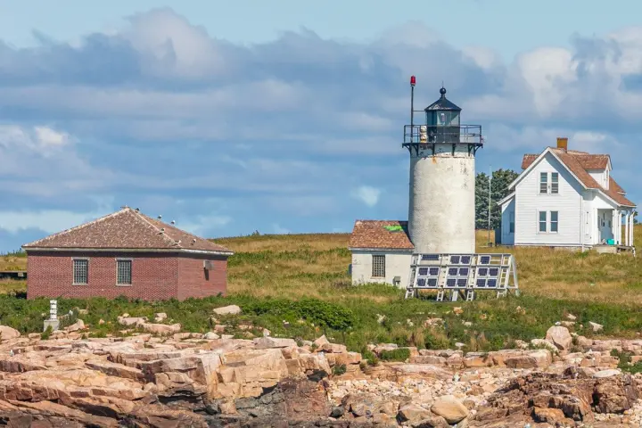 a large brick building with a mountain in the background