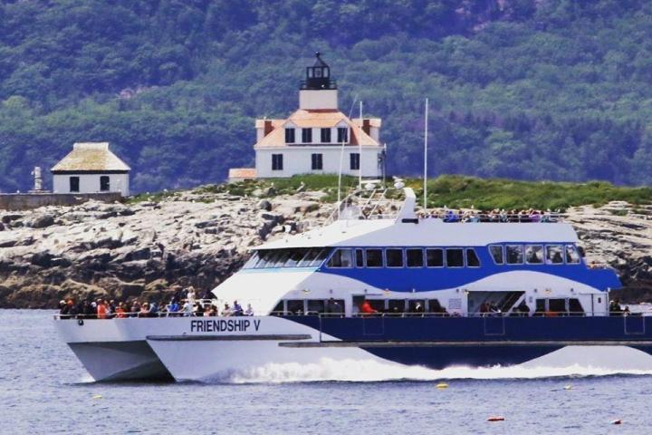 a small boat in a body of water with a mountain in the background