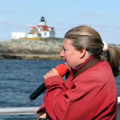 a man standing next to a body of water