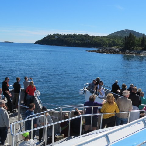 a group of people standing in front of a body of water