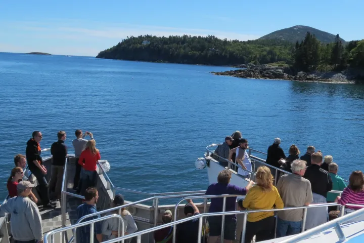 a group of people standing in front of a body of water