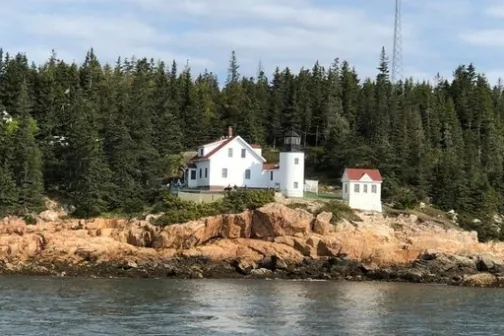 a body of water with a mountain in the background