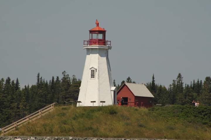 a small clock tower in front of a house