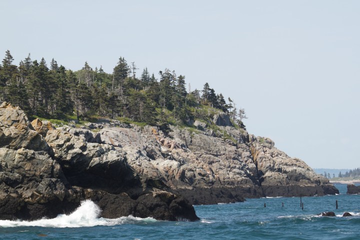 a large body of water with a mountain in the background