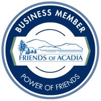 Blue and white 'Friends of Acadia' business member badge with mountains and trees.